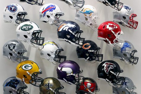 NFL team helmets are displayed at the NFL Headquarters in New York December 3, 2015. An impact absorbing helmet, a cushion for artificial turf and a rubberized tether that slows the speed of the head snapping back after a collision were products named winners of a research challenge co-sponsored by the NFL. Three separate innovation challenges are providing up to $20 million in research and technology development to better understand, identify and protect against brain injury.   REUTERS/Brendan McDermid