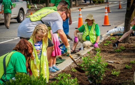 Volunteers and kids gardening in public